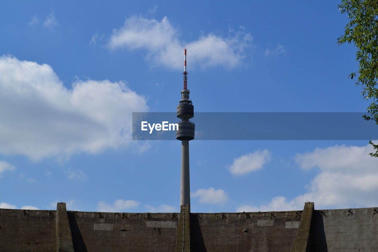 Low angle view of communications tower against sky