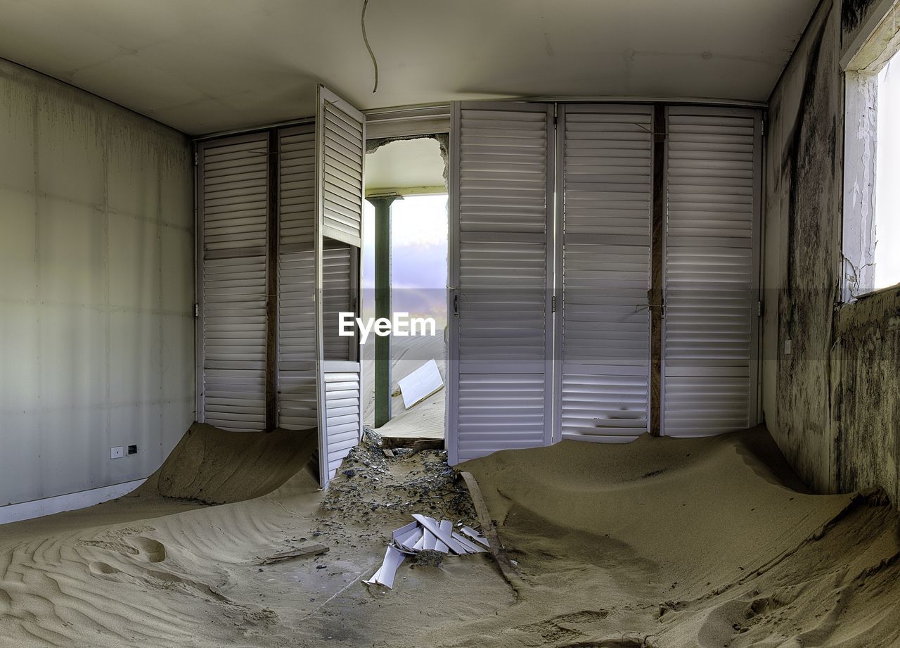Interior of abandoned home with sand