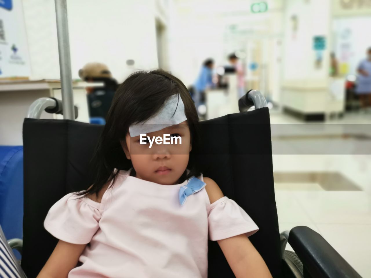 Girl sitting on wheelchair in hospital