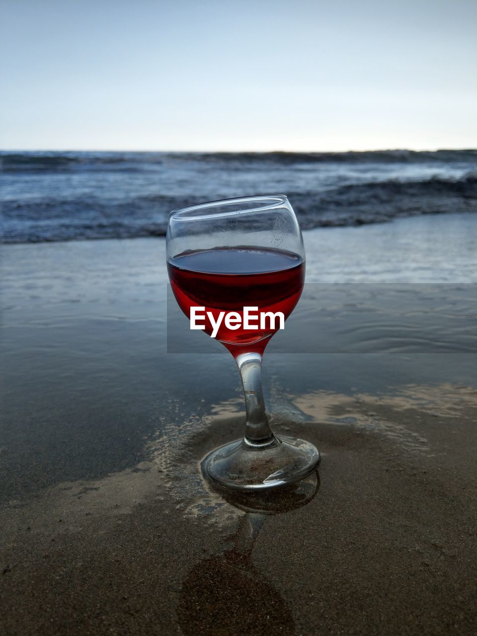 RED WINE GLASSES ON BEACH