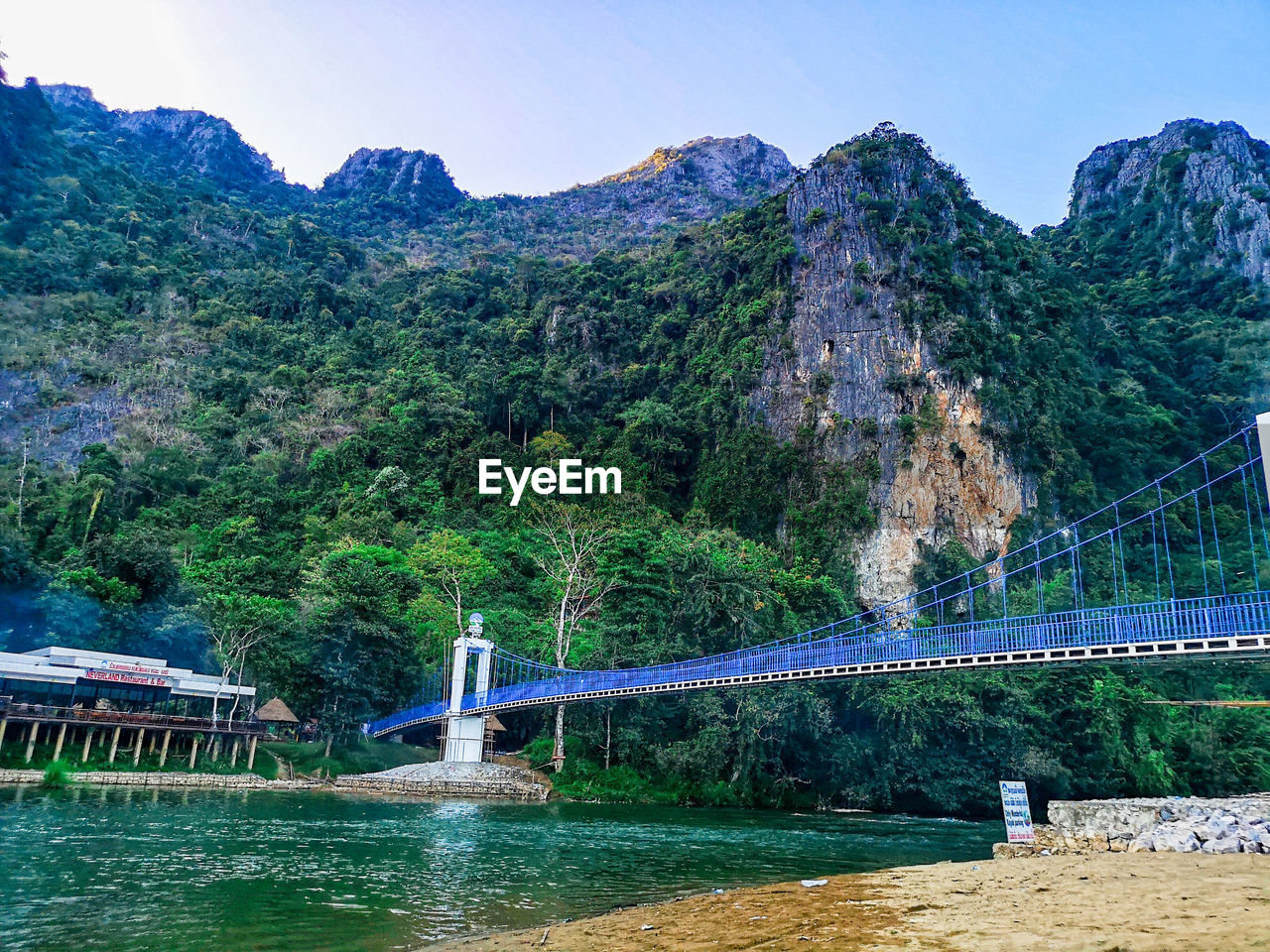 Bridge over river with mountain in background