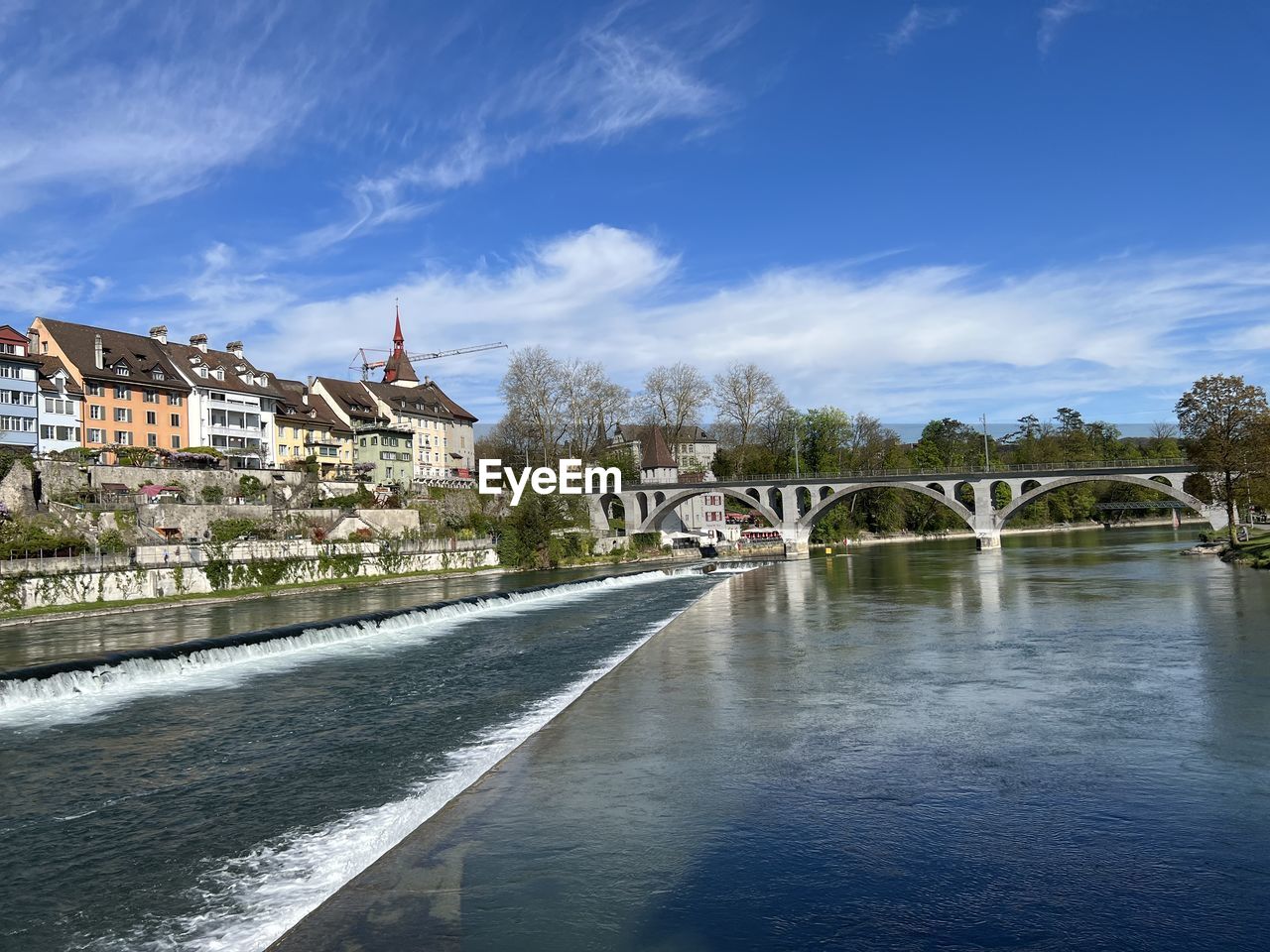 architecture, built structure, water, river, building exterior, sky, building, city, reflection, body of water, nature, travel destinations, waterway, cloud, blue, town, travel, vacation, bridge, cityscape, tourism, house, tree, no people, environment, landscape, waterfront, shore, the past, residential district, history, outdoors, coast, street, plant, day, transportation, religion, summer, land, place of worship, trip, holiday