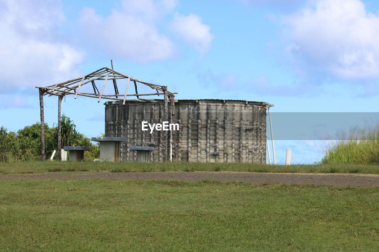 Built structure on field against sky