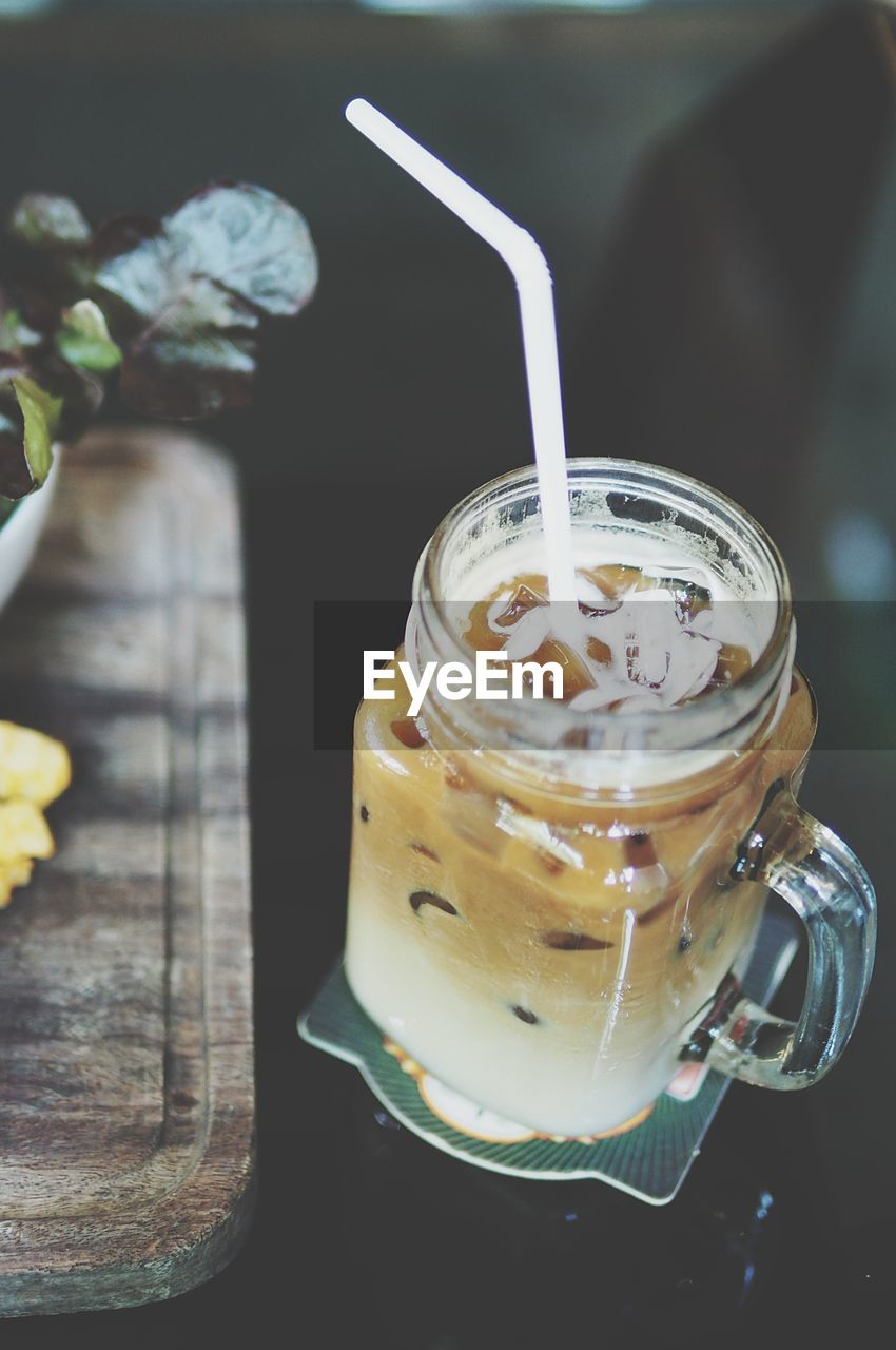 CLOSE-UP OF COFFEE CUP WITH JAR