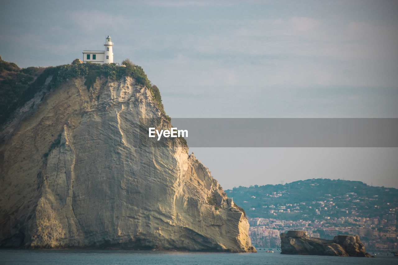 Rock formations by sea against sky