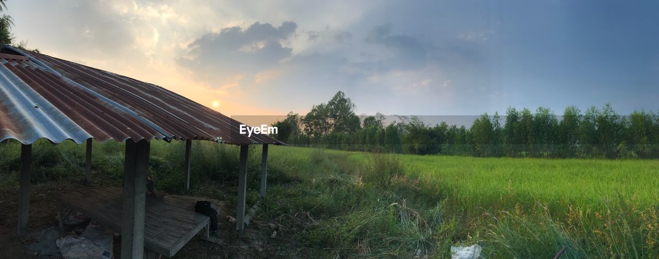 Panoramic view of field against sky during sunset