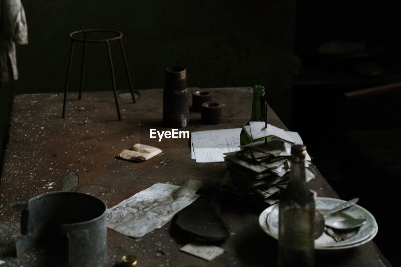 High angle view of bottles and eating utensils on table