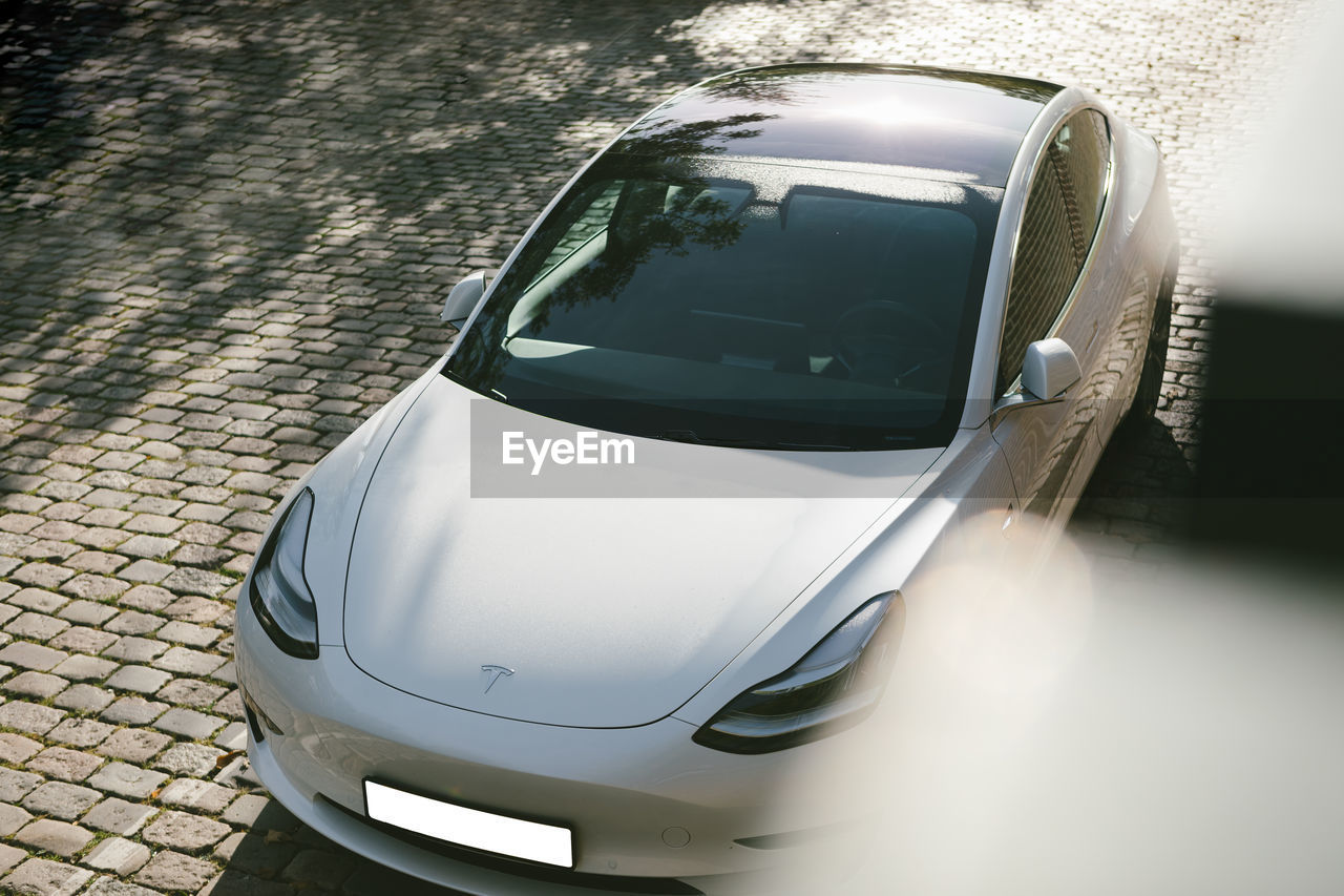CLOSE-UP OF CAR ON ROAD