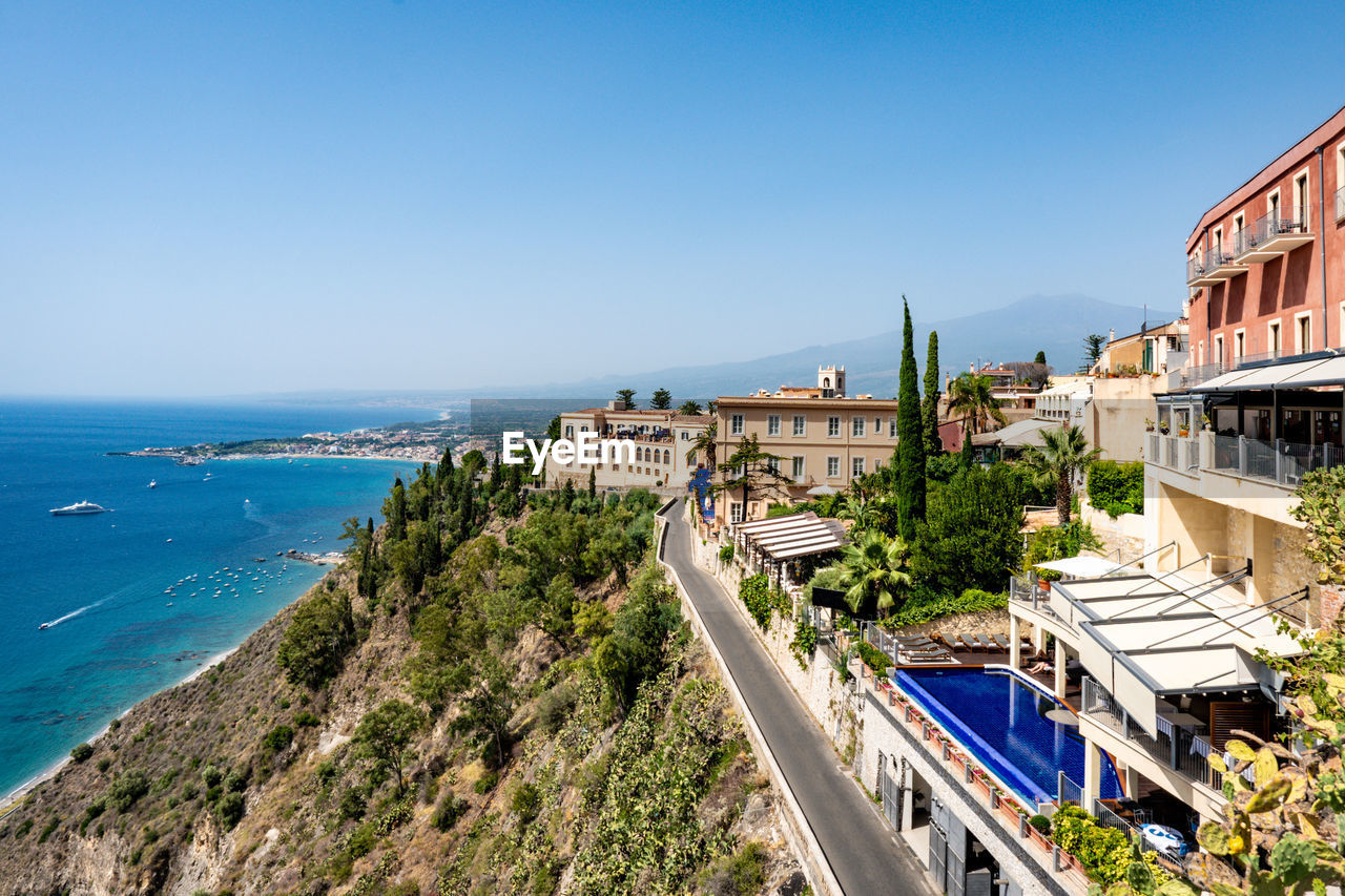 Hotel building in taormina with accommodation for tourists on a hill