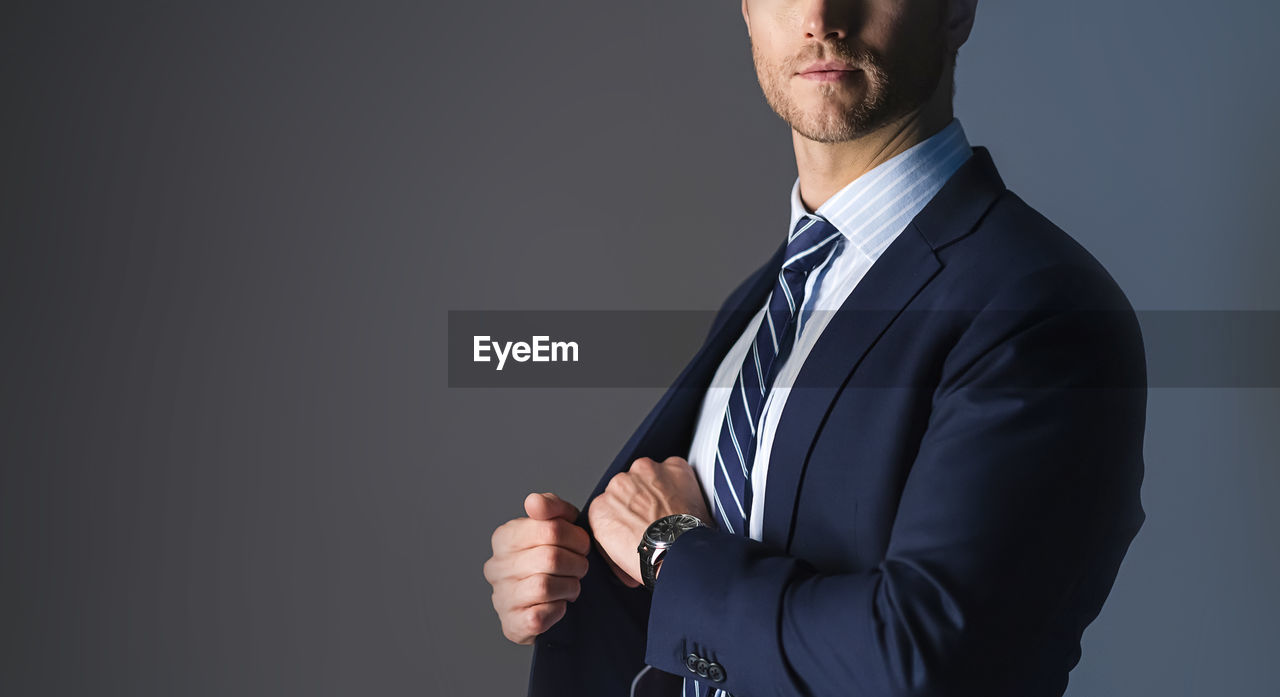 MIDSECTION OF A MAN AGAINST WHITE BACKGROUND