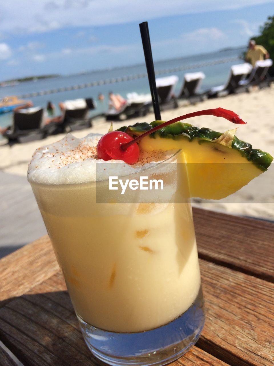 Close-up of cocktail on table at beach