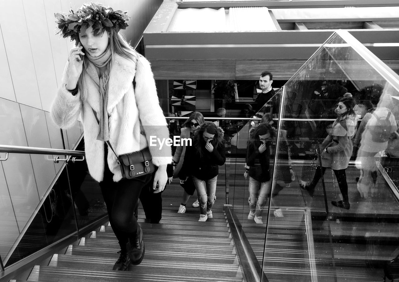 WOMAN STANDING BY RAILING