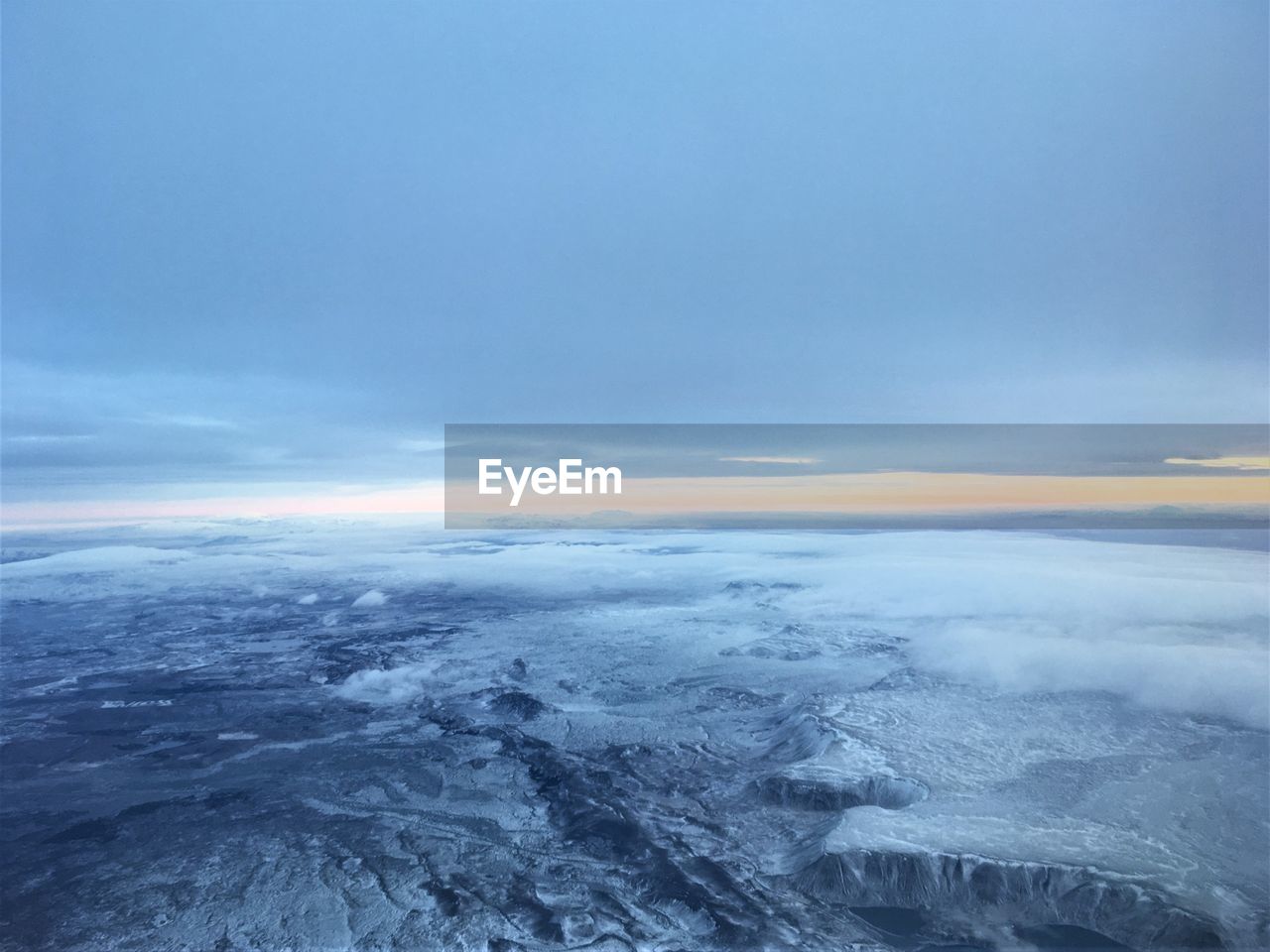 SCENIC VIEW OF CLOUDS OVER SNOW COVERED LANDSCAPE