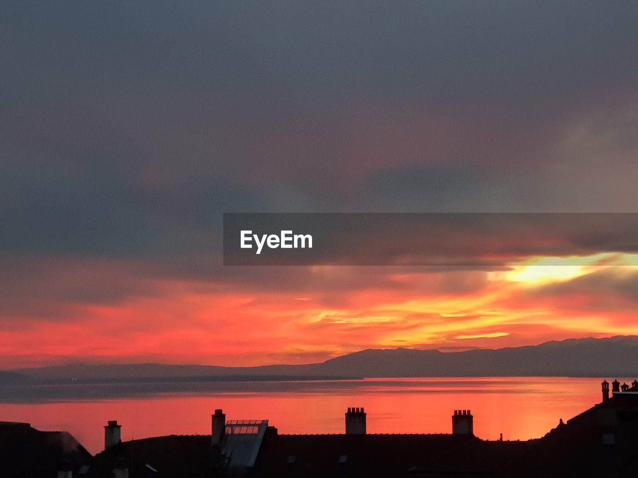 SCENIC VIEW OF SILHOUETTE BUILDINGS AGAINST DRAMATIC SKY