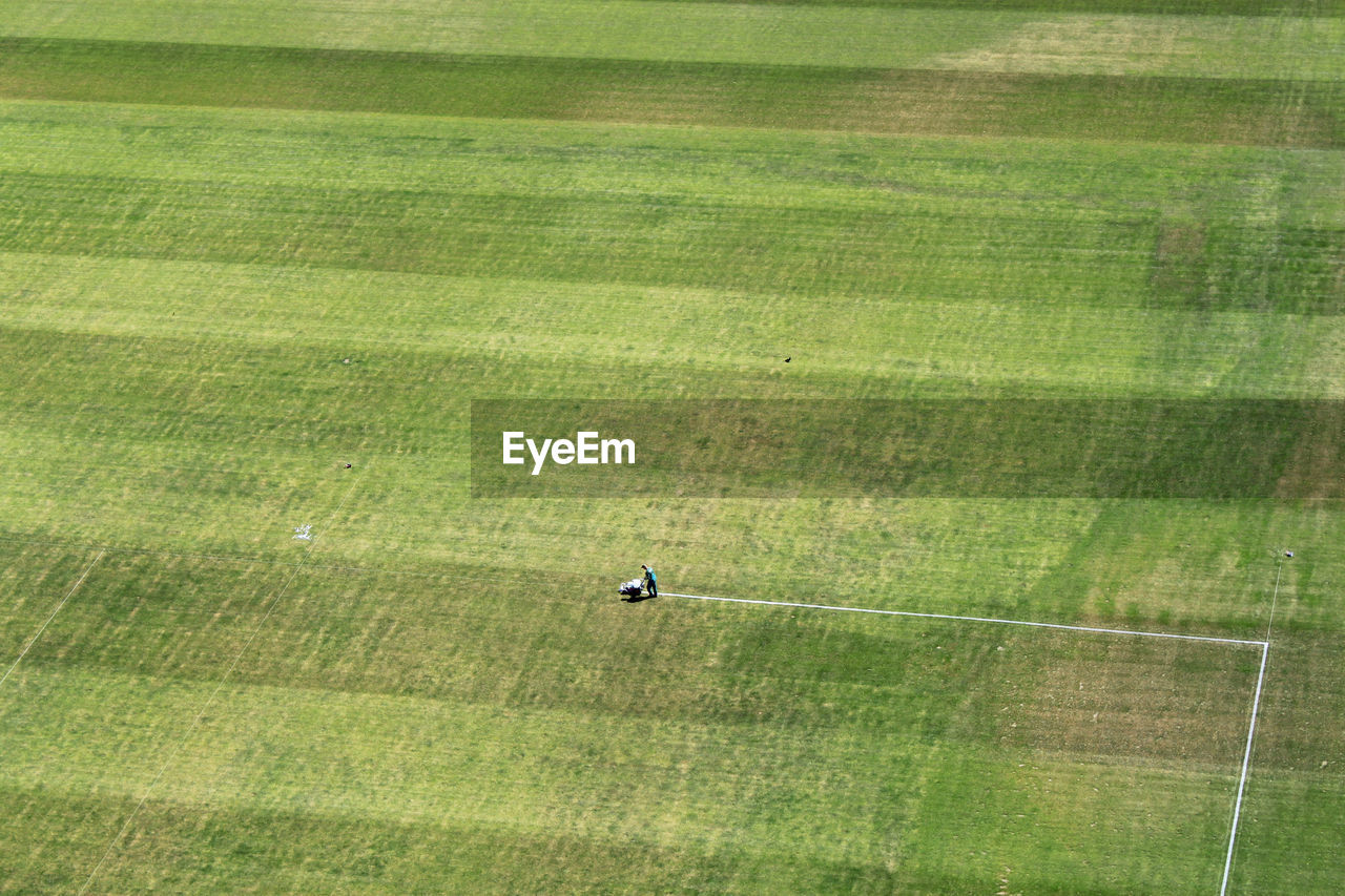 Aerial view of person making yard lines at soccer field