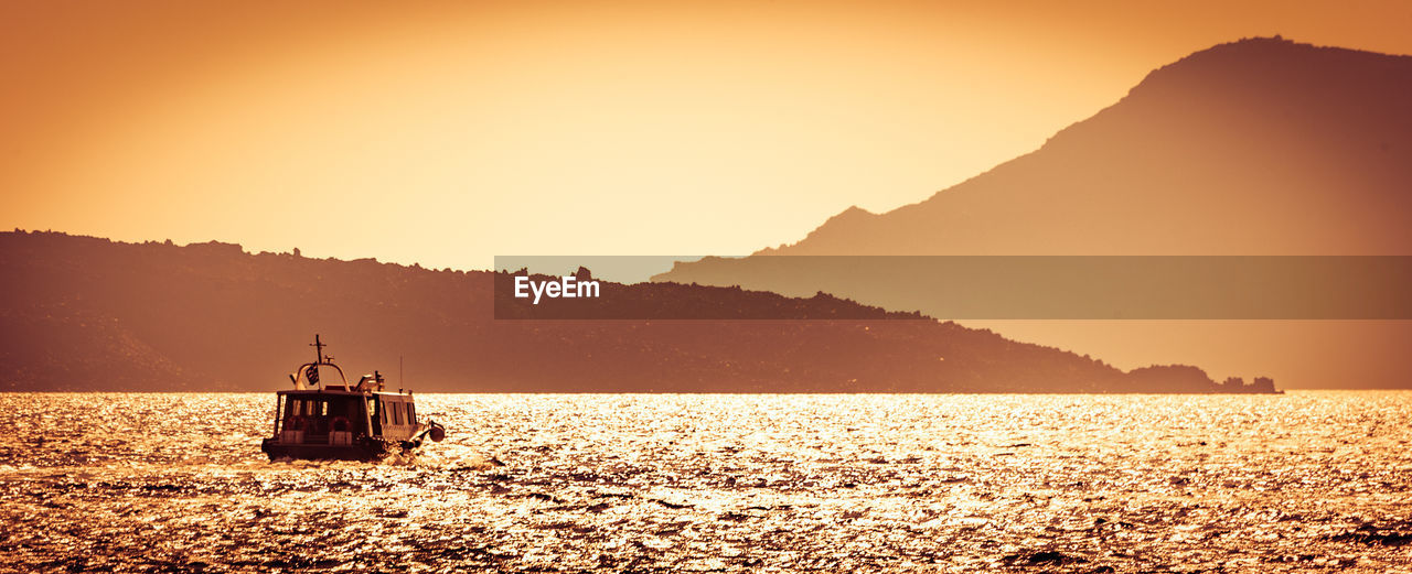 Scenic view of sea against clear sky during sunset