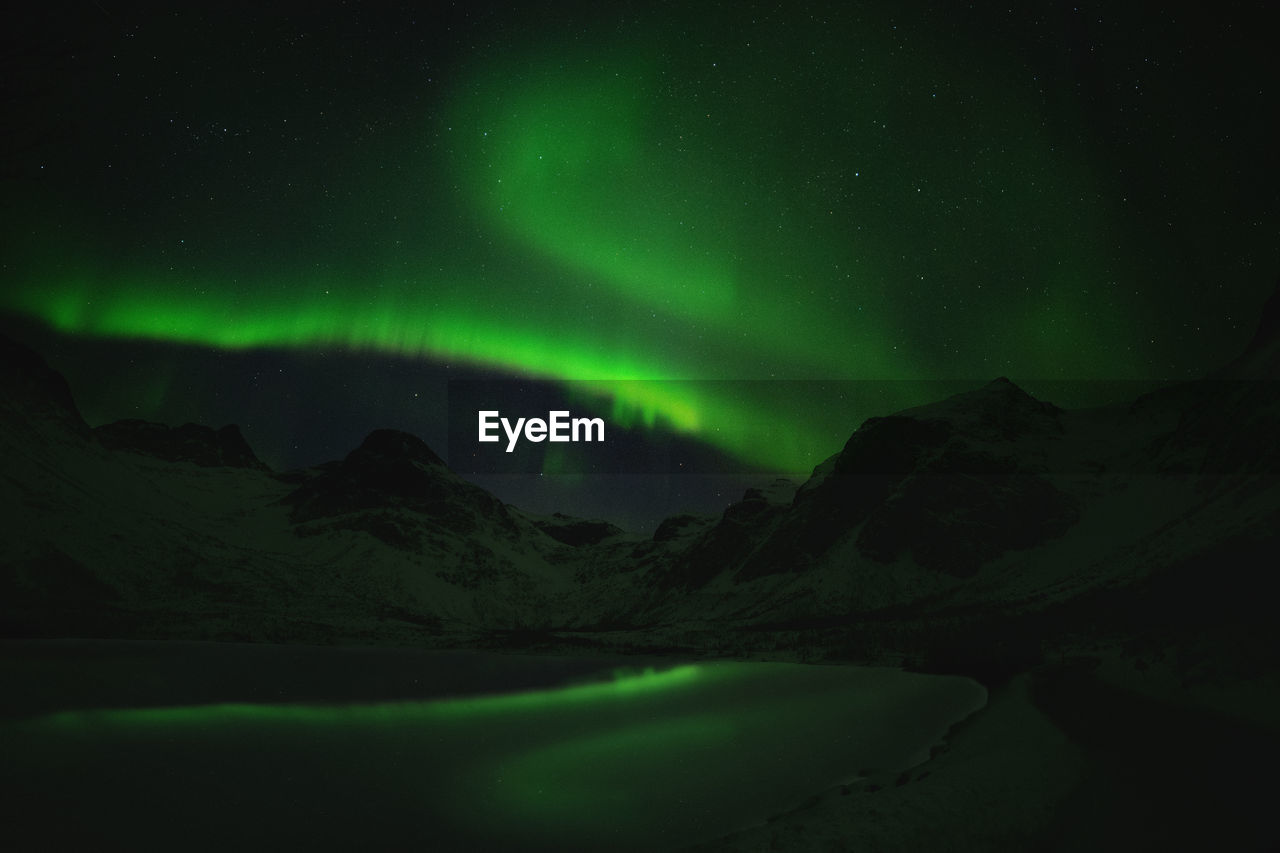 Scenic view of landscape against sky at night