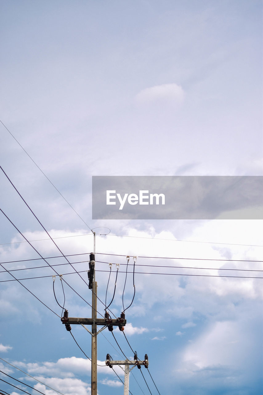 Low angle view of electricity pylon against sky