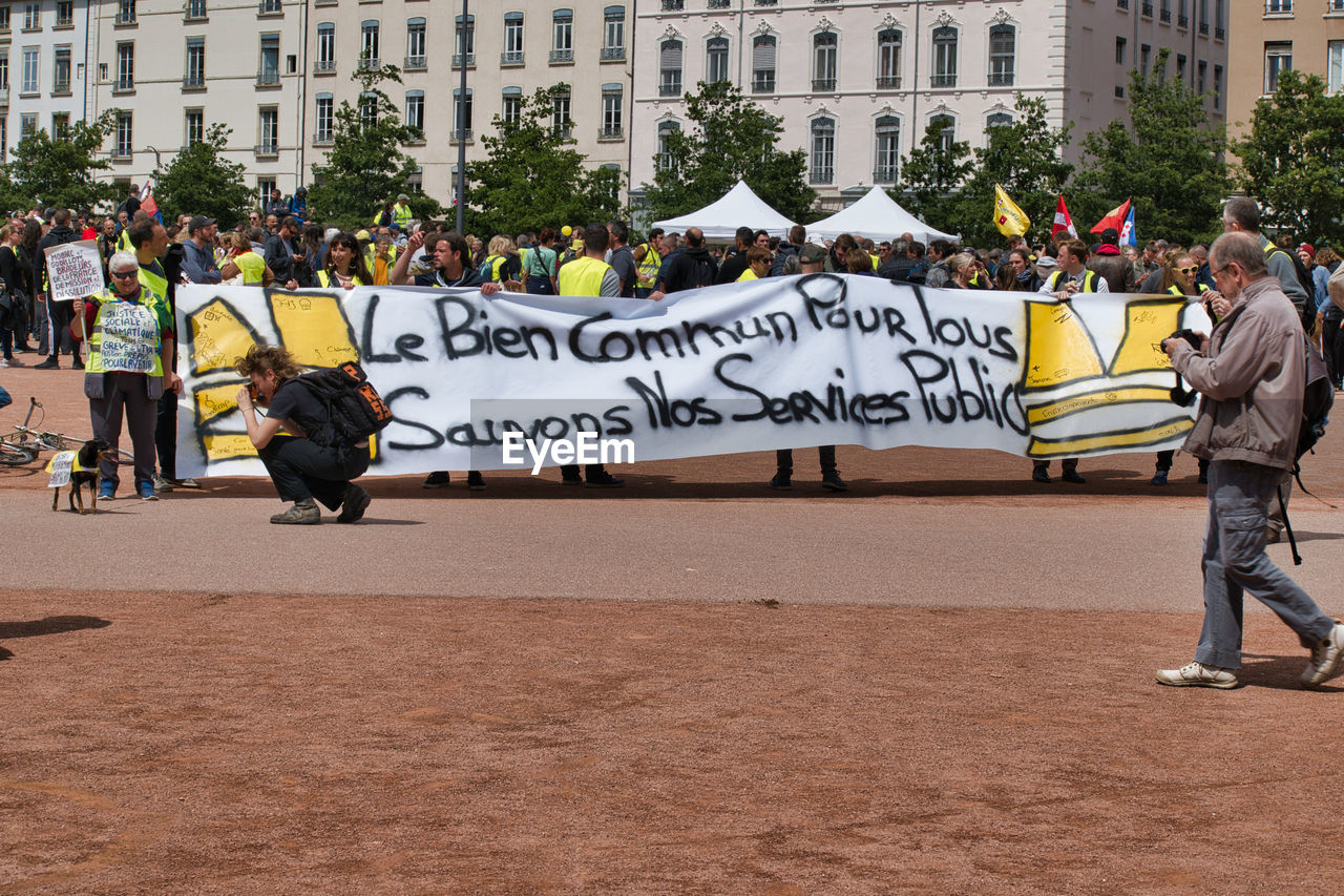 PEOPLE ON STREET AGAINST CITY BUILDINGS