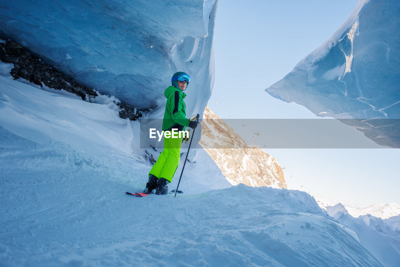 rear view of man skiing on snow covered mountain
