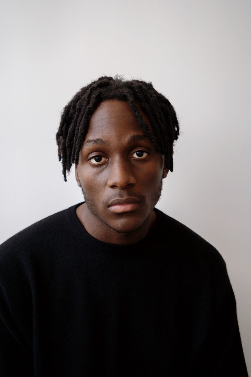 Young black man wearing jumper studio portrait