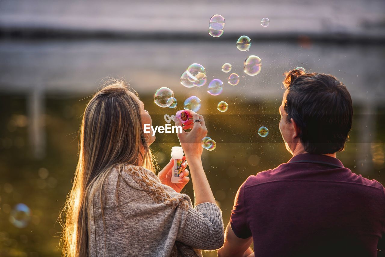 Rear view of women with bubbles