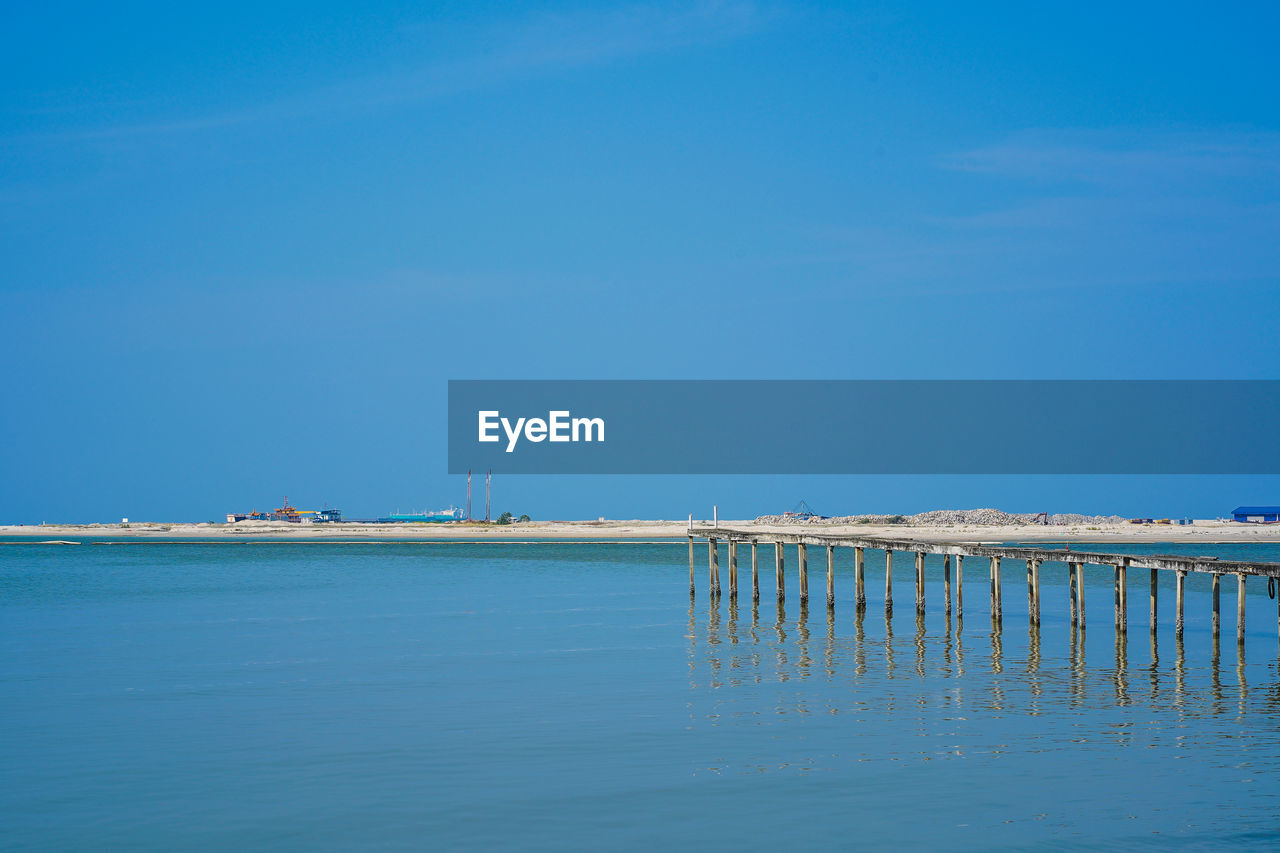 Scenic view of sea against clear blue sky