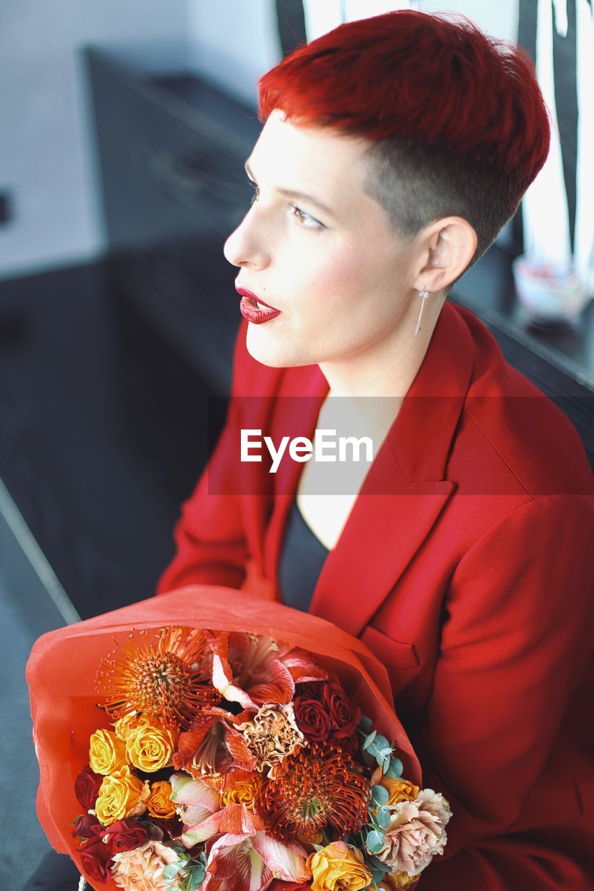 Side view of young woman having food