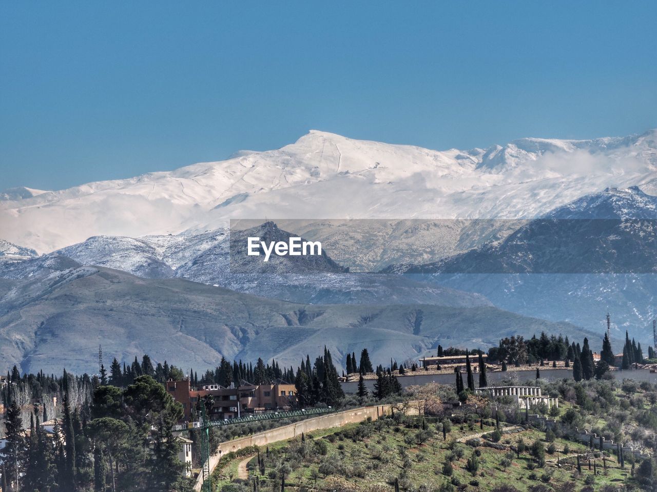 Scenic view of snow covered mountain against cloudy sky