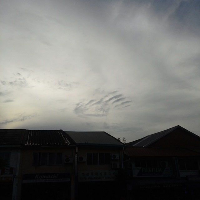 LOW ANGLE VIEW OF ROOF AGAINST CLOUDY SKY