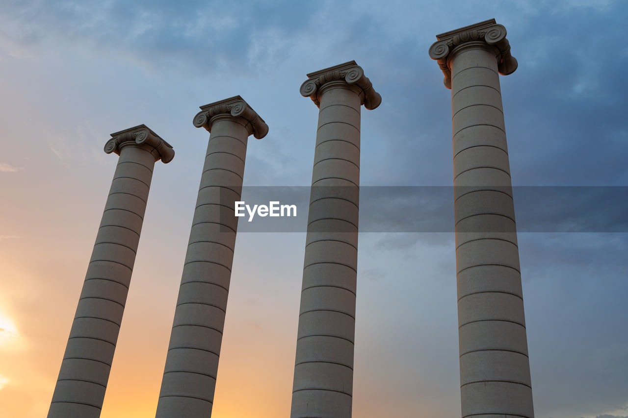 column, sky, architecture, cloud, industry, tower, nature, built structure, environment, low angle view, sunset, no people, outdoors, smoke stack, building exterior, architectural column, power generation, pollution, landmark, business finance and industry, environmental issues, factory, social issues, outdoor structure, chimney