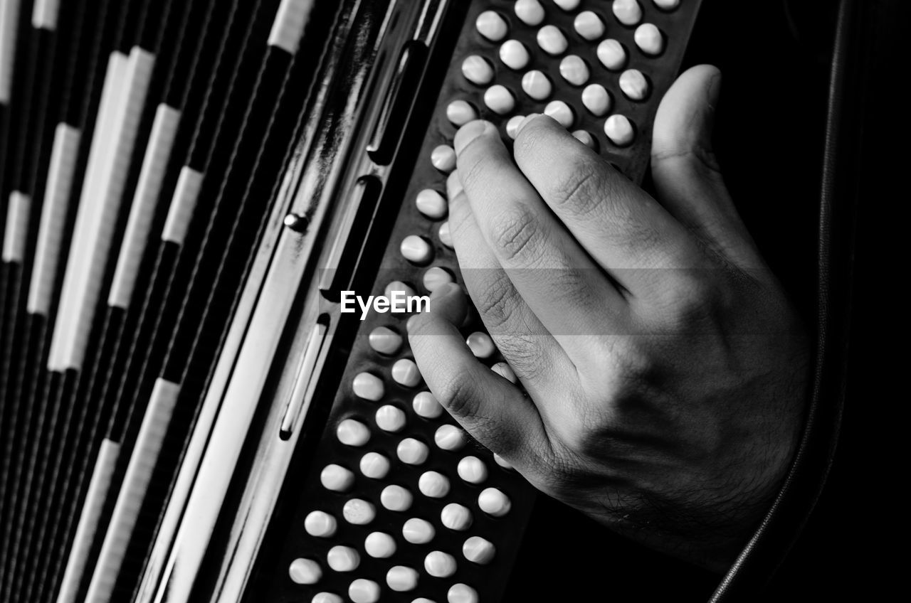 Close-up of hands playing accordion