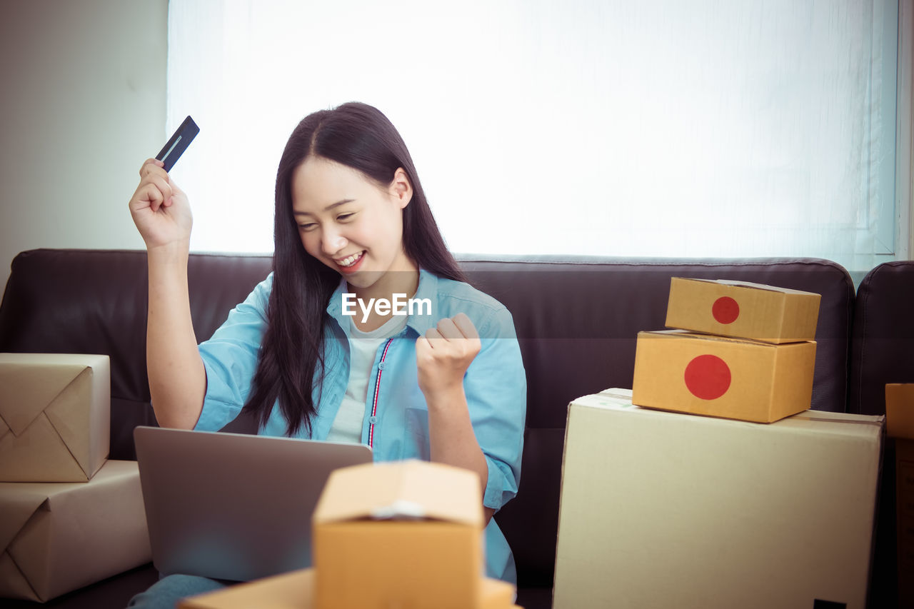 Smiling businesswoman looking at laptop