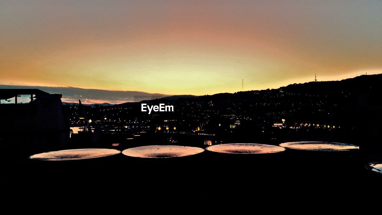 SILHOUETTE OF BUILDINGS AGAINST CLEAR SKY DURING SUNSET