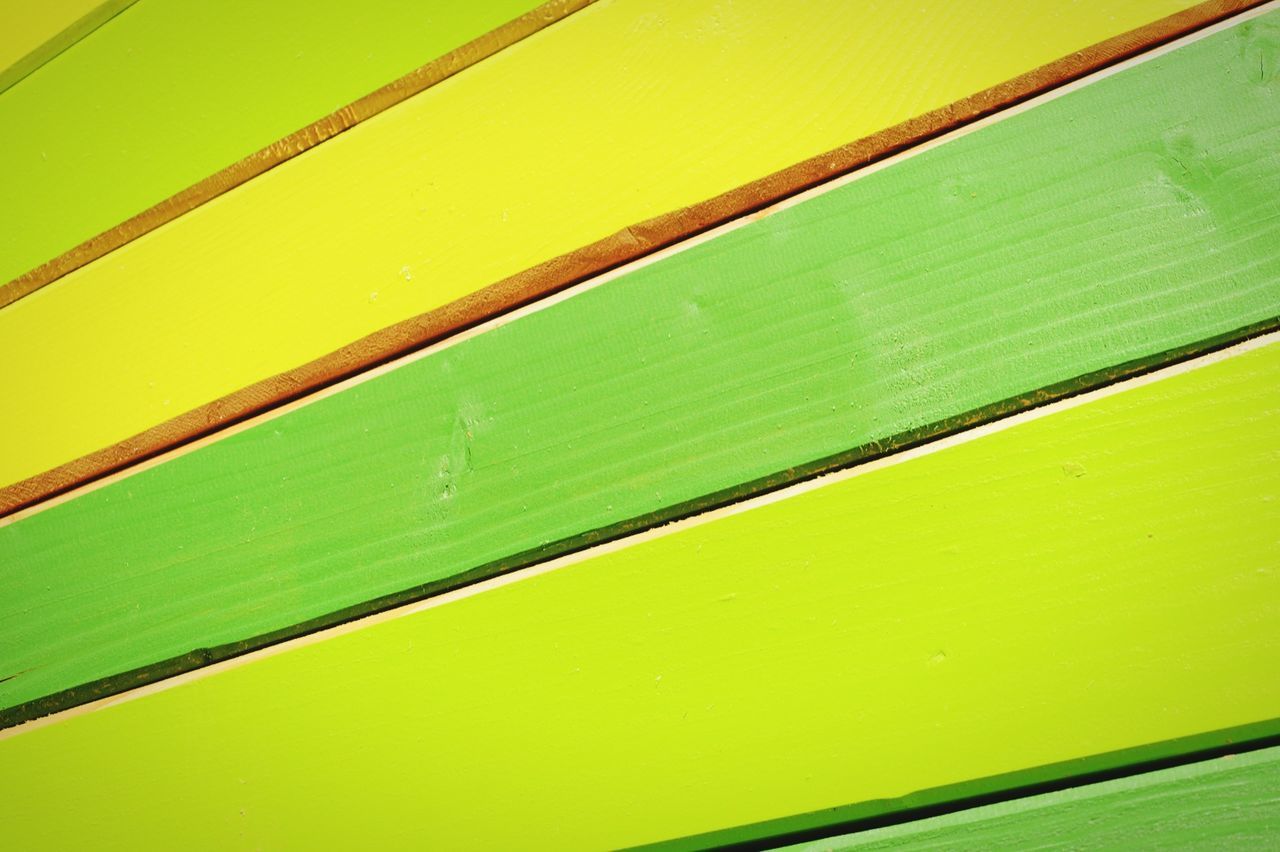 Close-up of green and yellow fence