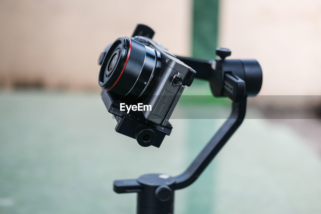 CLOSE-UP OF CAMERA WITH REFLECTION ON METAL