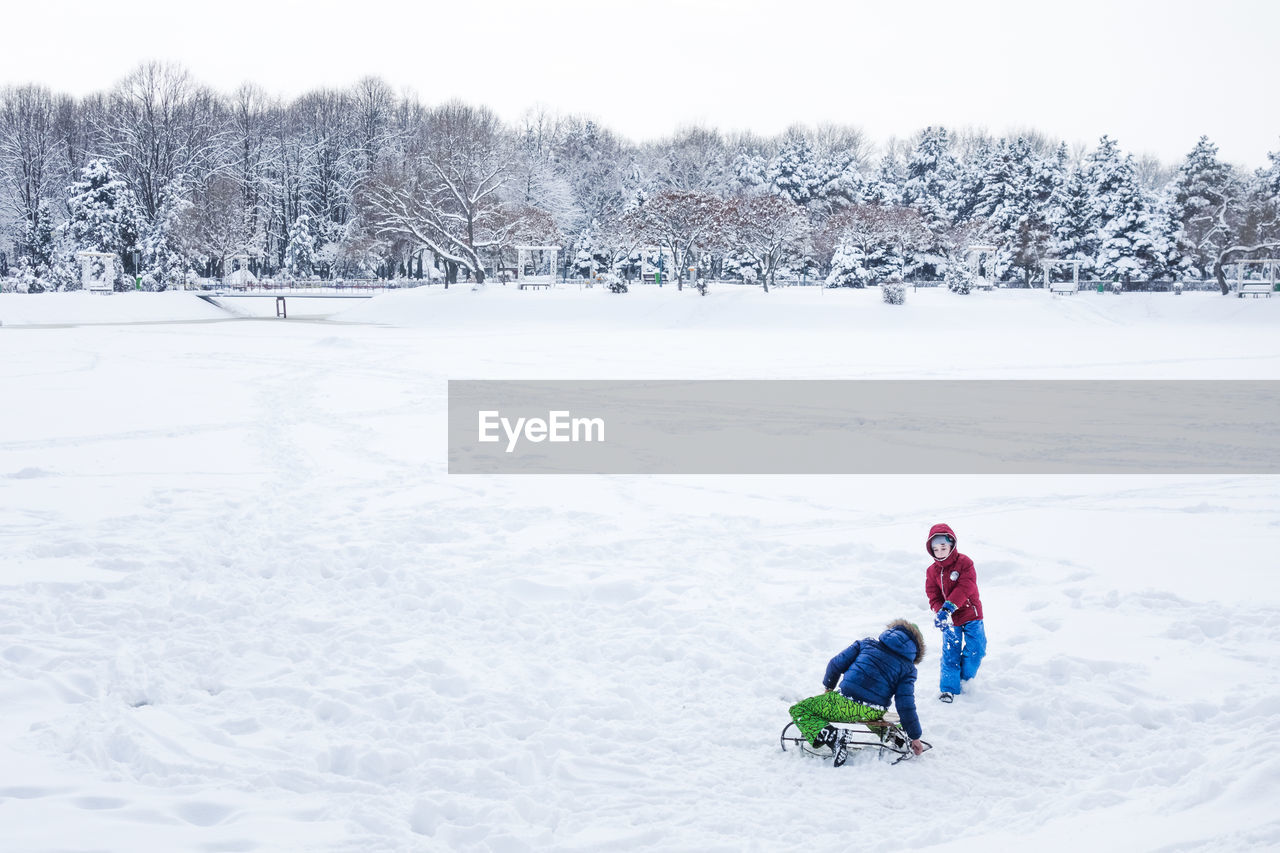 GIRL ON SNOW COVERED FIELD