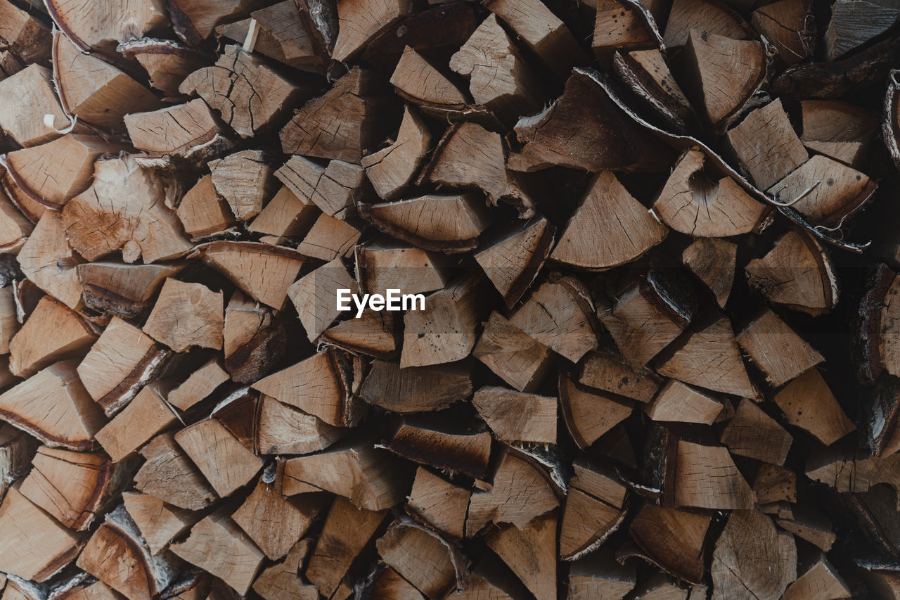 backgrounds, full frame, large group of objects, timber, brown, wood, log, abundance, firewood, lumber industry, soil, pattern, no people, deforestation, forest, power generation, wall, tree, woodpile, floor, flooring, environmental issues, textured, fossil fuel, repetition, heap, close-up, branch, shape, nature, leaf, stone wall, day, rock, brick