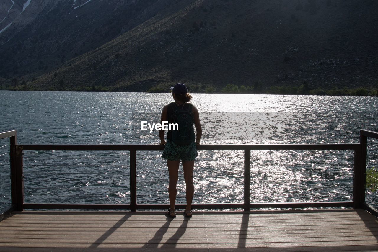 Rear view of woman on pier over sea