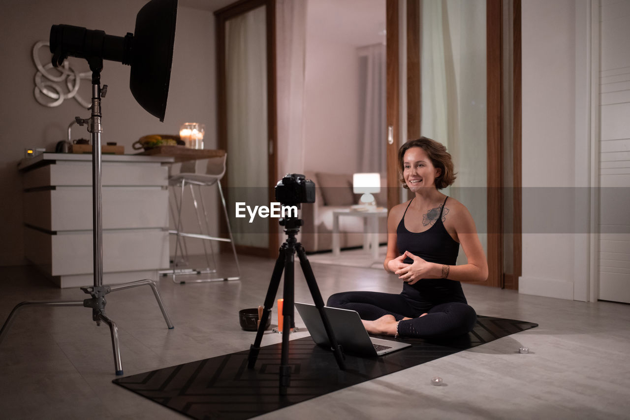 Yoga trainer speaking with online clients