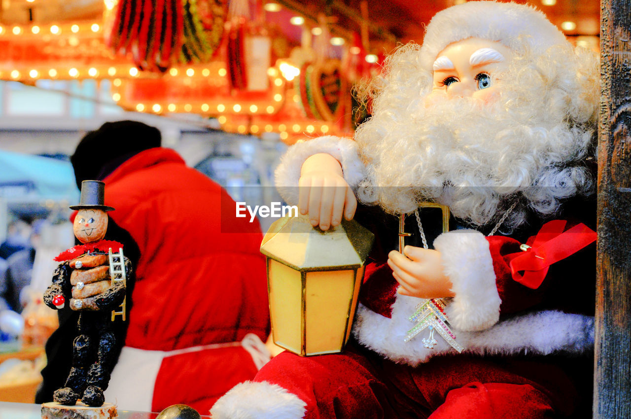 CLOSE-UP OF CHRISTMAS DECORATIONS IN SNOW AT NIGHT