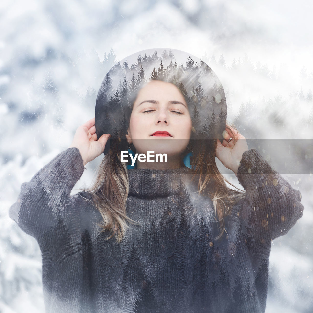 Double exposure image of woman with eyes closed and forest during winter