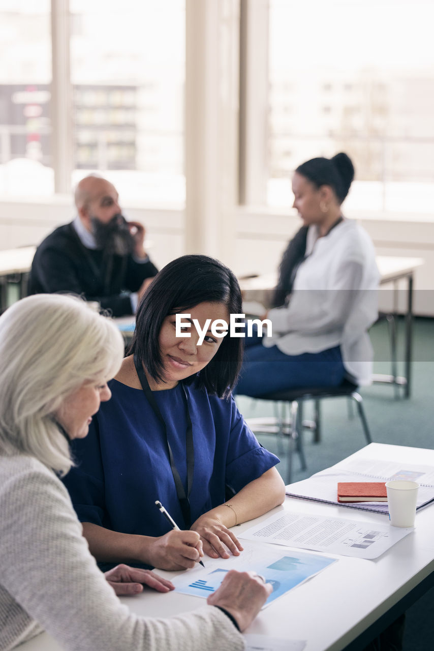 Adults working together in class