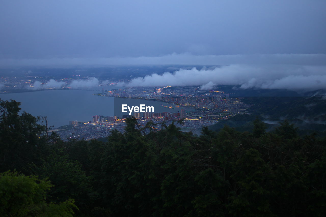 environment, sky, architecture, mountain, nature, landscape, tree, city, plant, cloud, land, water, horizon, scenics - nature, sea, building, travel destinations, travel, building exterior, beauty in nature, built structure, tourism, no people, outdoors, morning, fog, social issues, cityscape, forest, blue, dusk, high angle view, night, tranquility