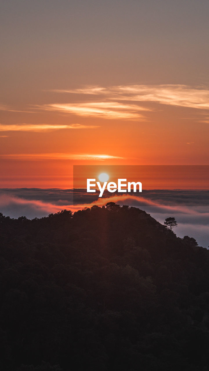 Scenic view of silhouette landscape against romantic sky at sunset