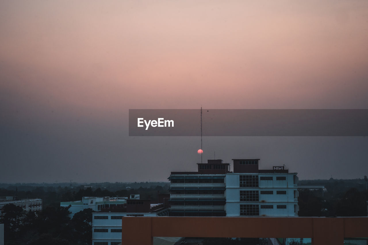 CITY BUILDINGS AGAINST SKY DURING SUNSET