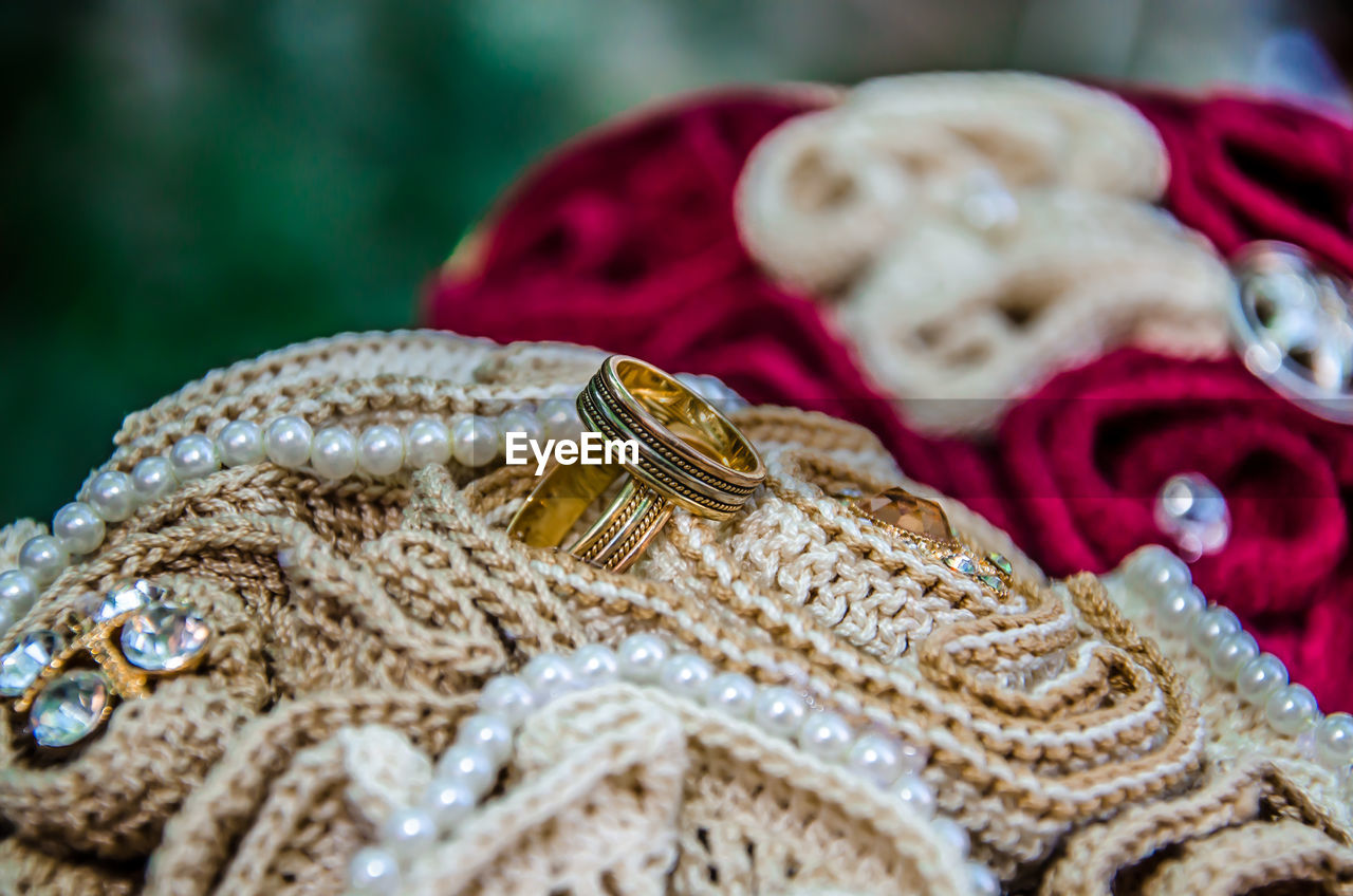 Close-up of wedding rings on fabric