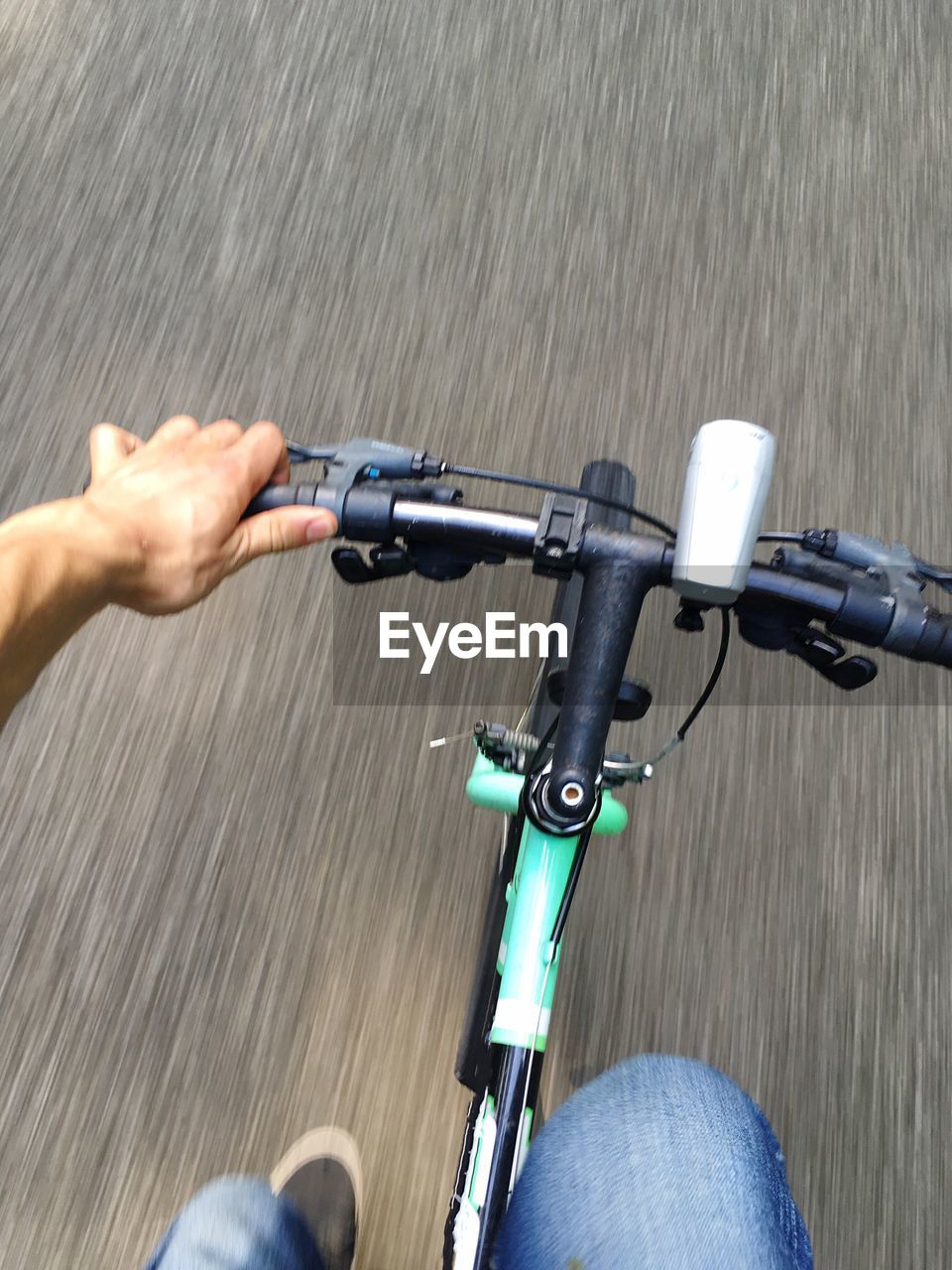 Cropped image of man cycling on road