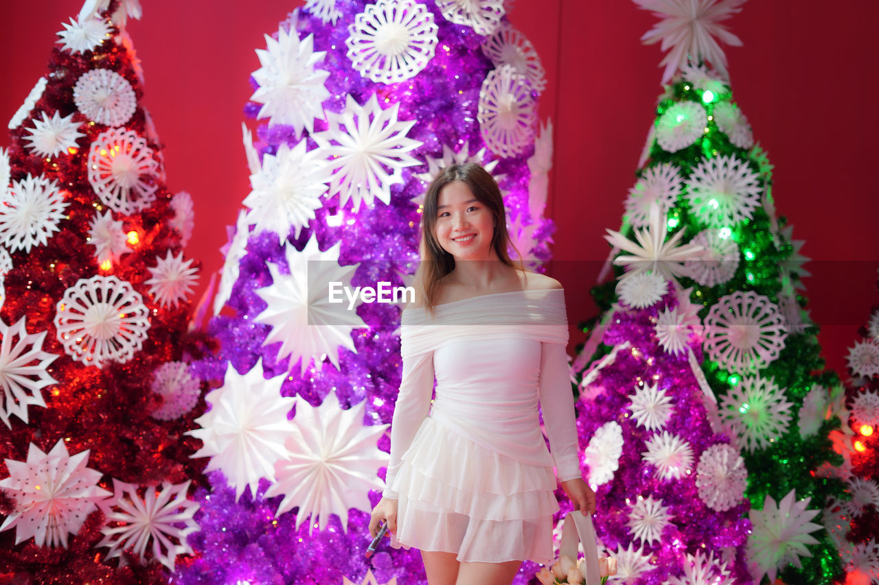 portrait of woman with christmas decorations on table