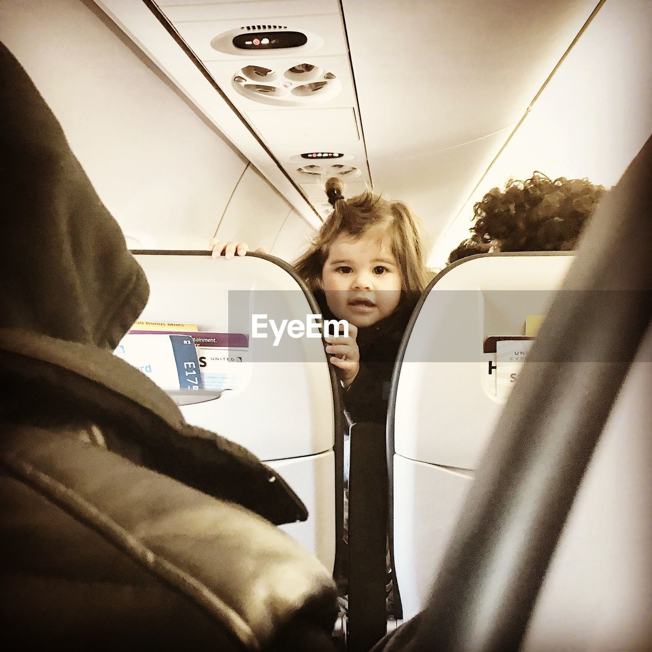 YOUNG WOMAN SITTING IN BUS